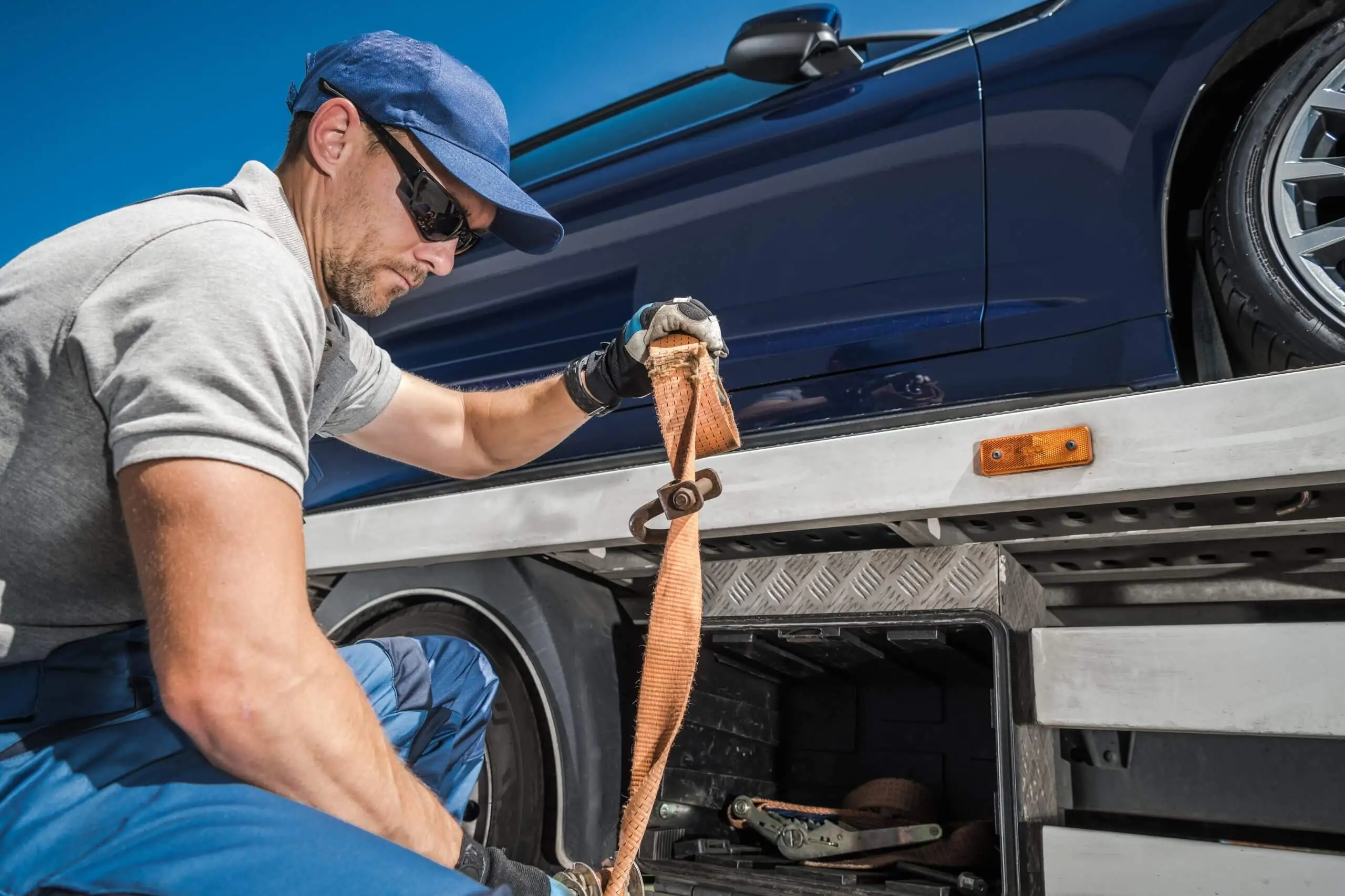 worker-securing-repossessed-vehicle-on-his-towing In this guide, we will detail one critical aspect of the car transport process which is load distribution on multiple-car trailer trucks...